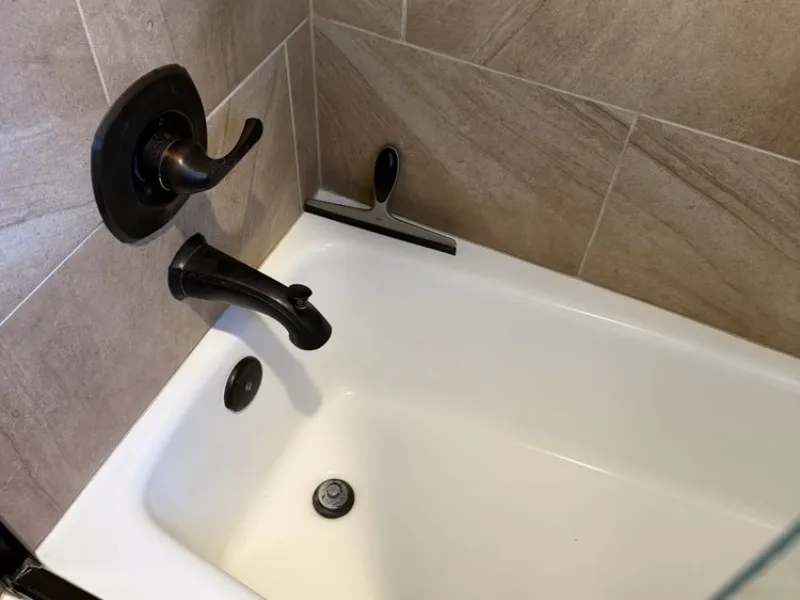 A&A Plumbing technician installing a bathtub valve during a San Diego bathroom plumbing project