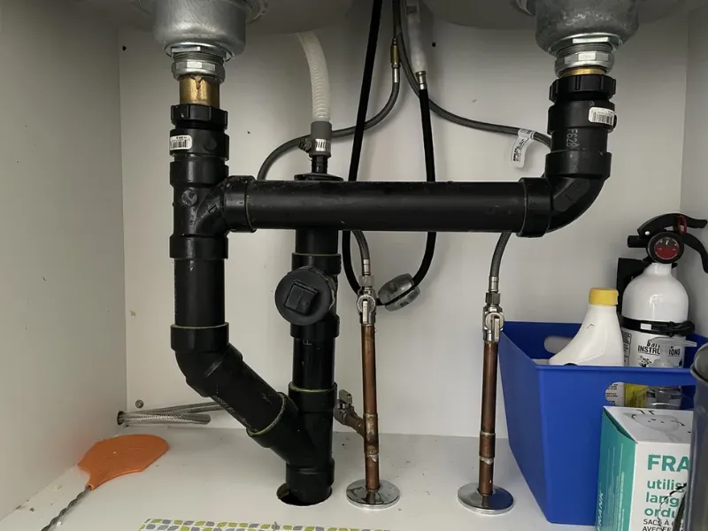 Kitchen drain pipe showing scale and debris buildup