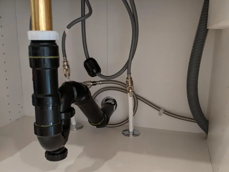 Kitchen sink drain and plumbing inspected by an A&A Plumbing technician in San Diego